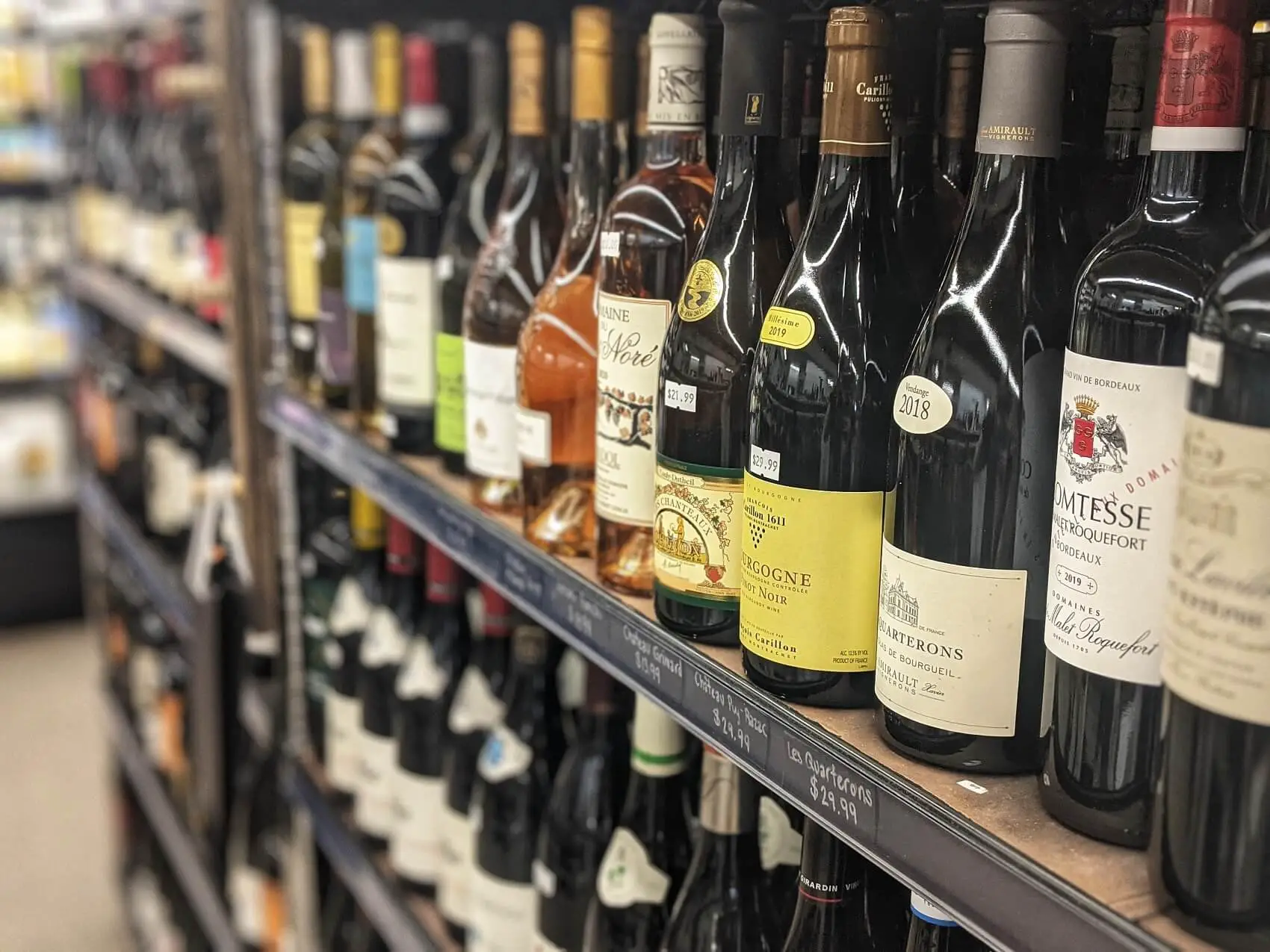 wines on store shelf - inexpensive gifts for wine lovers