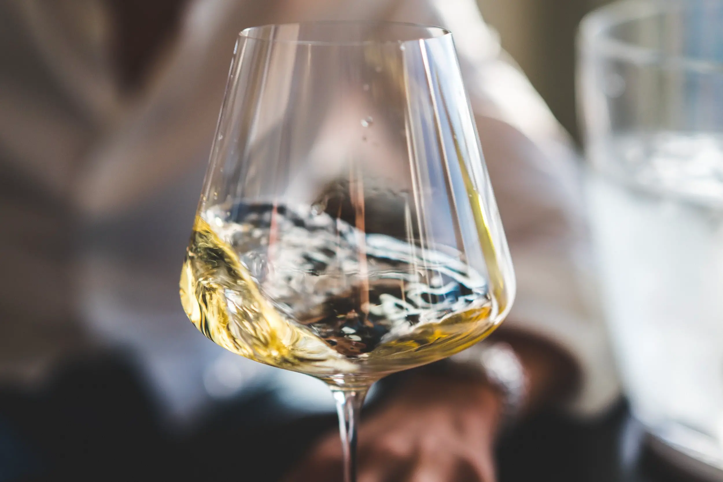 white wine swirling in glass