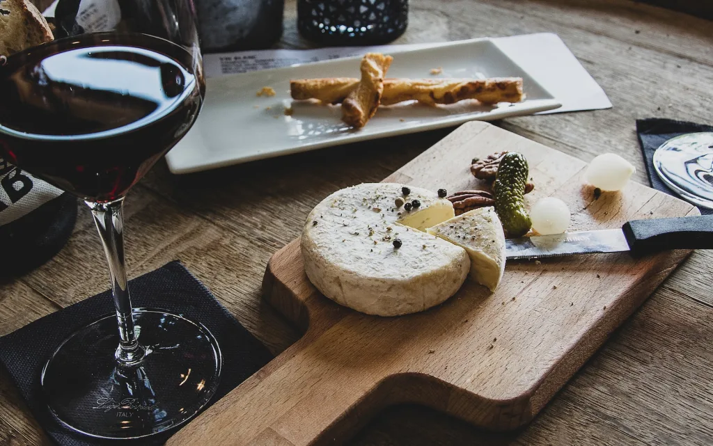 clear martini glass on brown surface - pinot noir cheese pairing suggestions