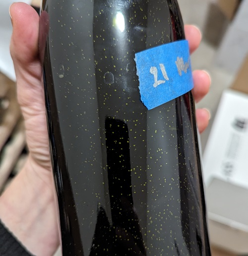 How to Tell If Wine Has Gone Bad Without Opening - specks in wine bottle - bacteria
