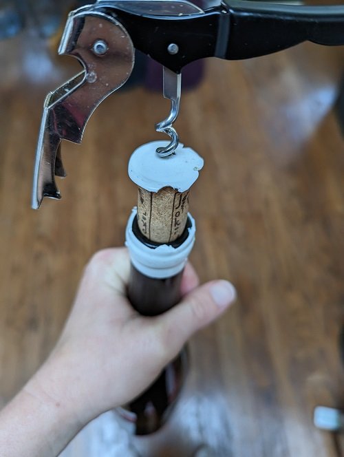 how to open a waxed wine bottled - put corkscrew-in-demonstration