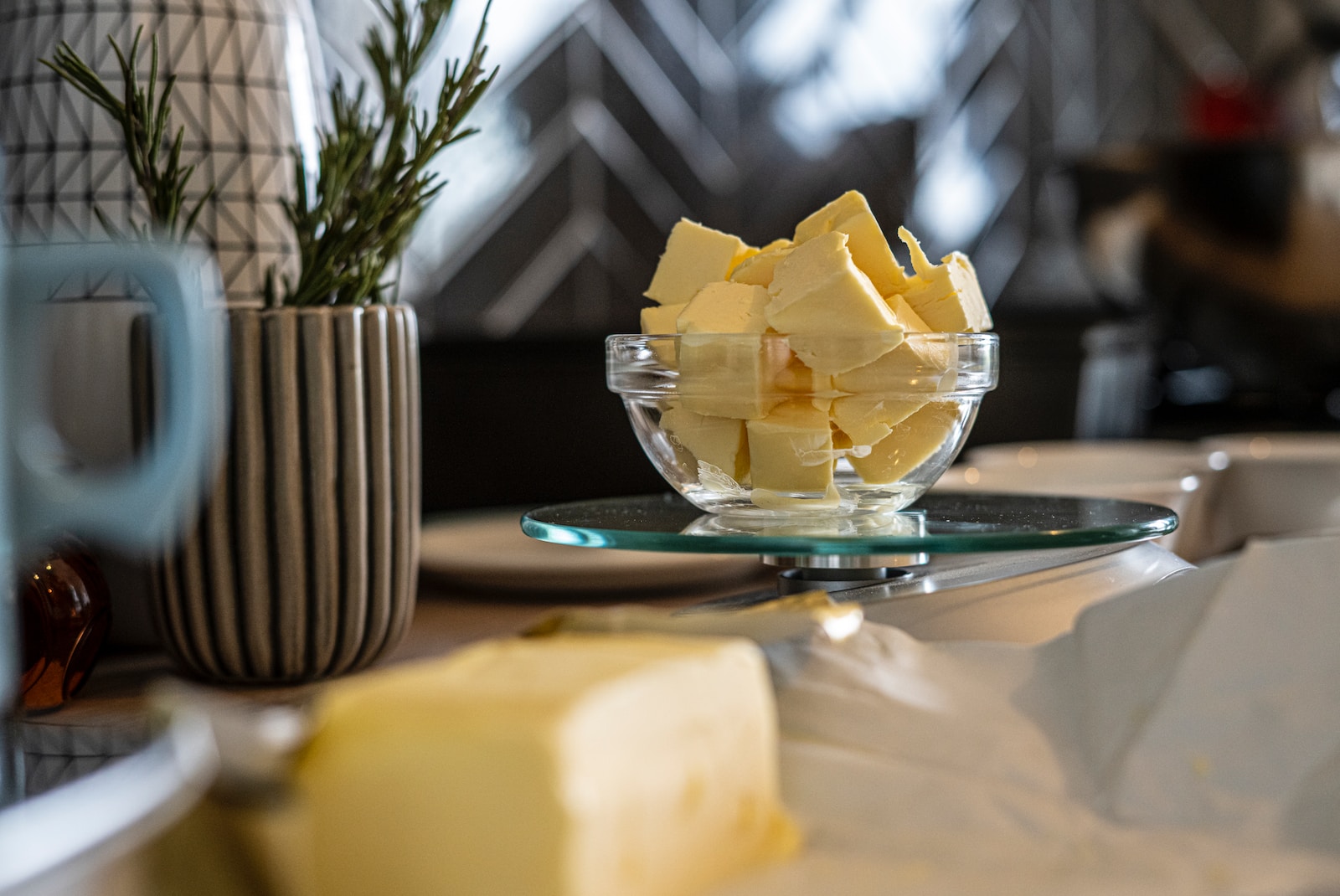 yellow cheese on green and white ceramic plate - why does wine taste like butter?