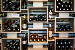 brown wooden wine bottle rack - dolcetto vs barbera - wine shelf