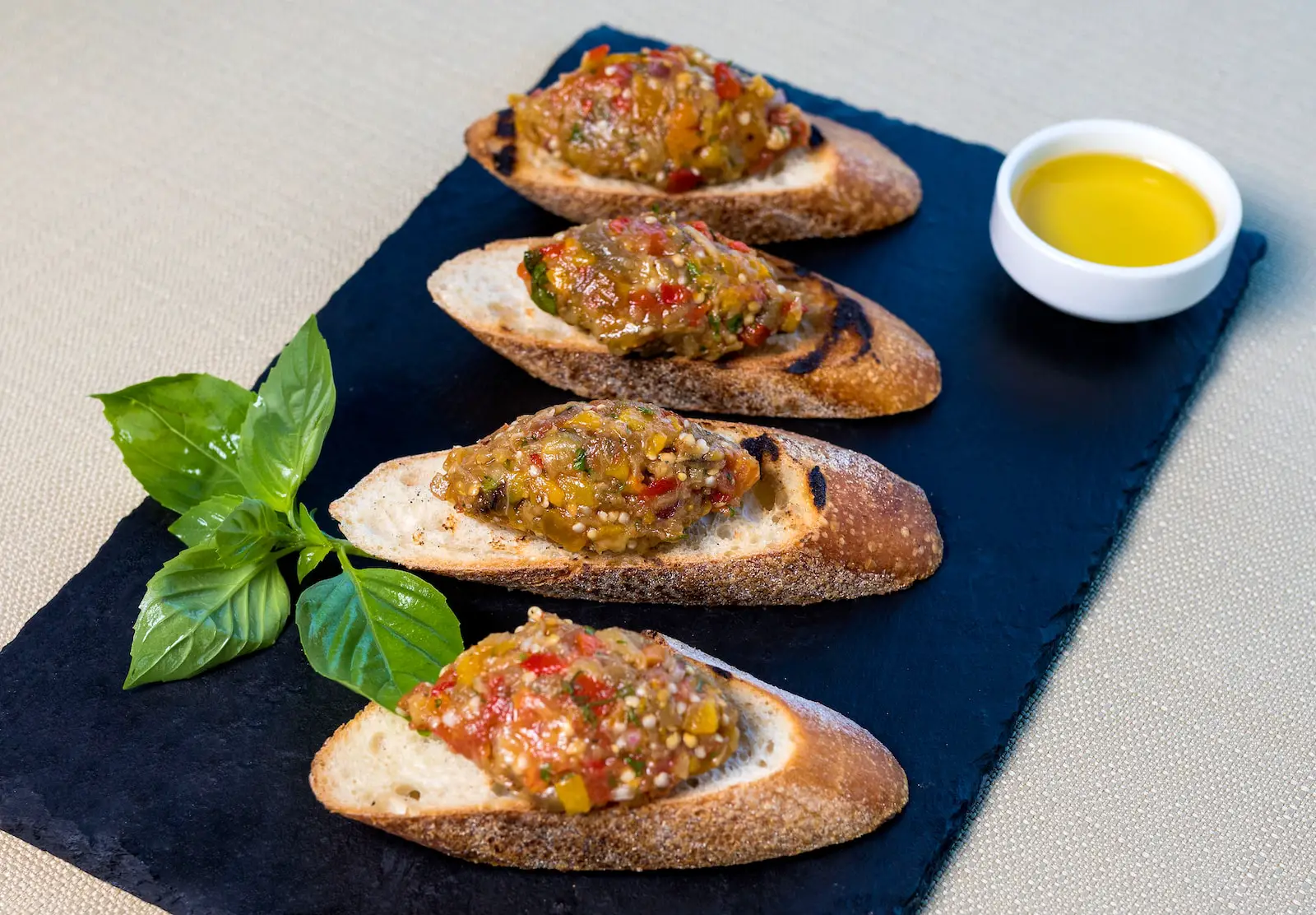 bread with vegetable on blue plate - tapas grenache vs merlot