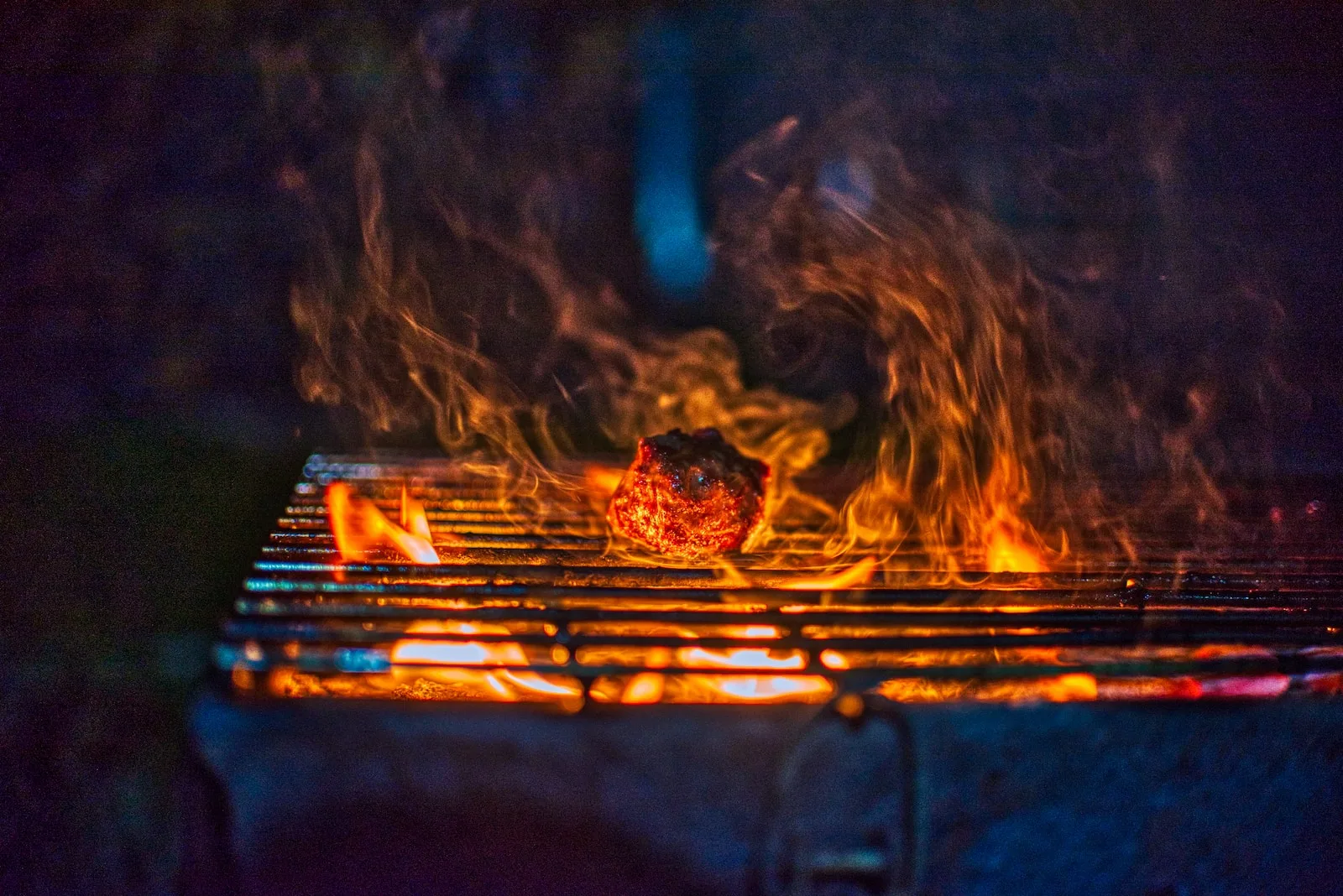 fire on black charcoal grill - syrah vs malbec wine
