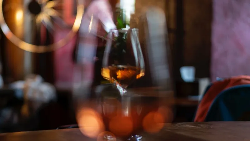 rose wine and cheese pairing - clear wine glass on brown wooden table